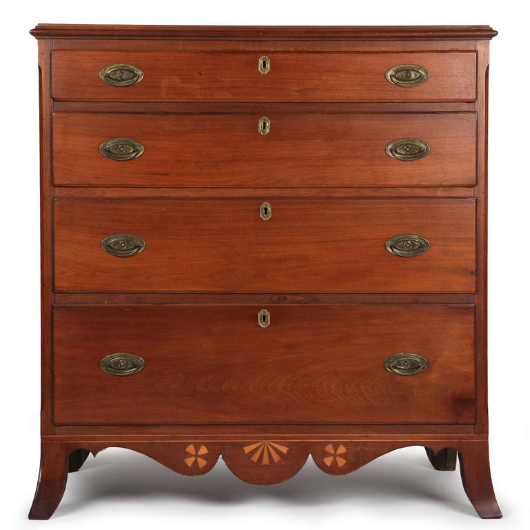 While the Hepplewhite form employing splayed french feet in case pieces is well developed, even common, this fine chest of drawers exudes a certain strength that is uncommon in Federal period works of the Hepplewhite style. The solid walnut and