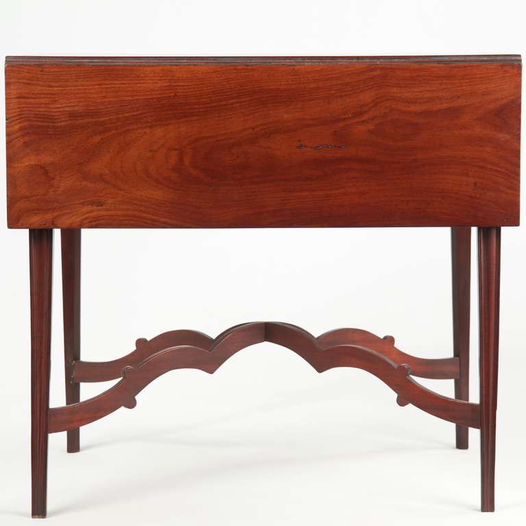 This is an exceptional American Chippendale Pembroke table, crafted with a very dense and vibrant grained Cuban mahogany top. The flow of the grains is incredibly attractive, the intense ribbing through the center made accentuated by the smooth