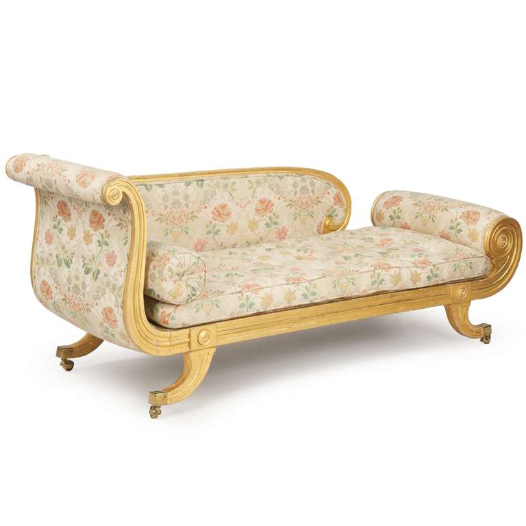 This is a remarkable and very fine Regency Recamier of unusually robust form and quality. The strong Greco-Roman influence is evident in the bold curls and classical shaping. The left side raises sharply in a sleigh-form, the arm cresting outward in