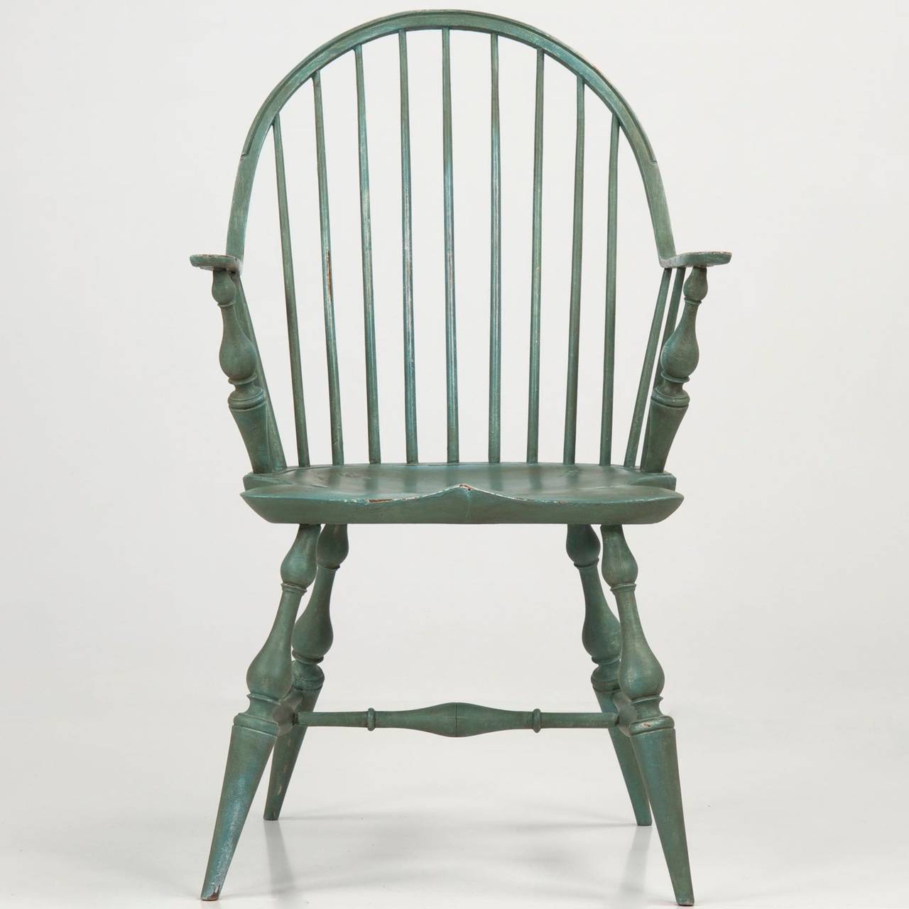 This very attractive benchmade reproduction of the 18th Century New England originals is crafted in a manner entirely authentic to it's inspiration.  With a hand planed and carved plank seat, through which the turned maple legs tenon through and