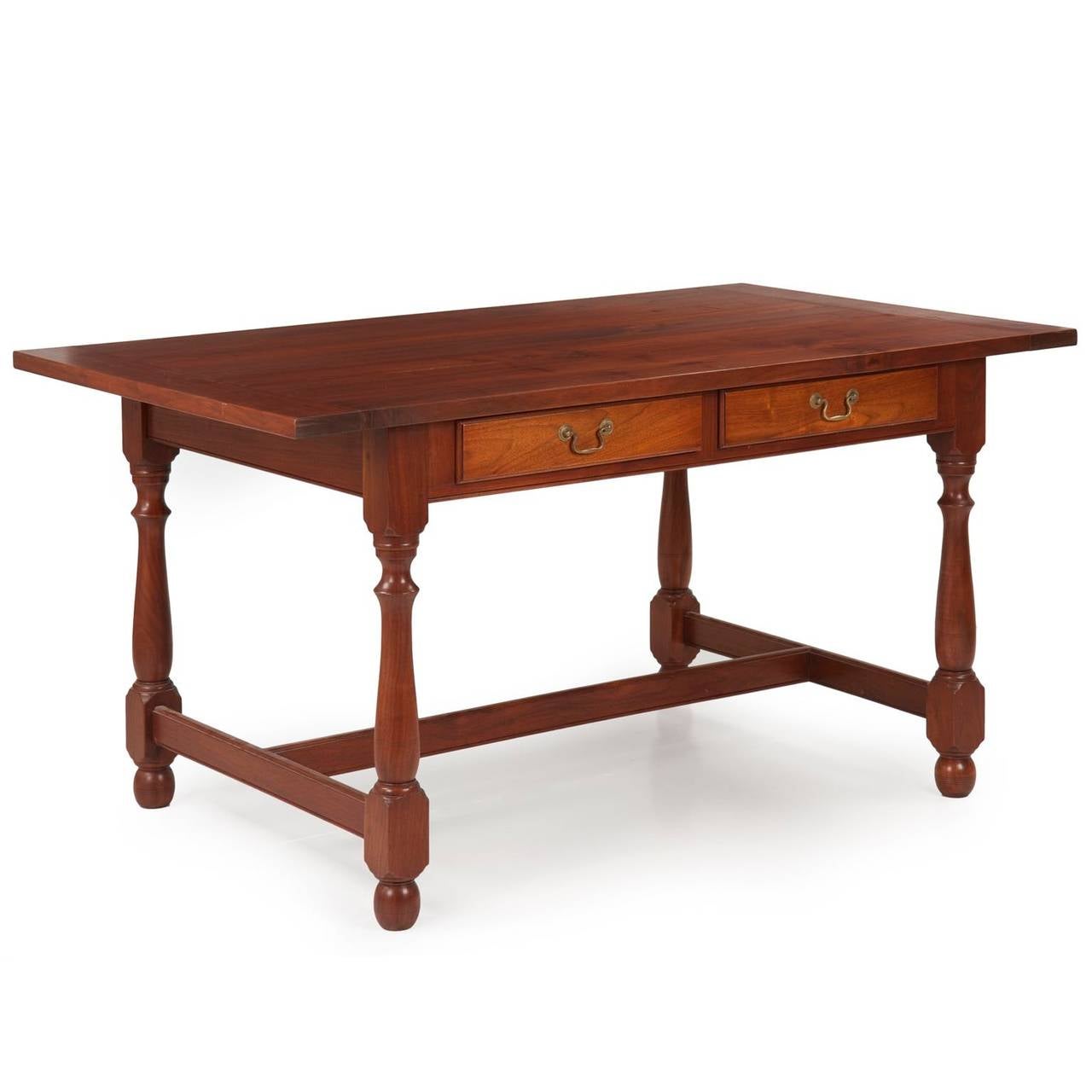 Crafted using inordinately thick and heavy solid walnut planks, this fine benchmade dining table is a fine representation of the strong and stoic William and Mary style of Pennsylvania during the first half of the 18th Century.  It is a piece built