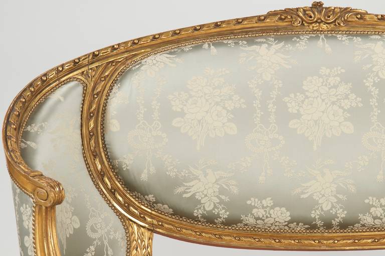 A fine work from the late 19th to early 20th century, the surface is finished in an extremely attractive and vibrant burnished gilding. The crest is intricately carved with upward sprawling acanthus leafage along the twisted rope-and-ball framing,
