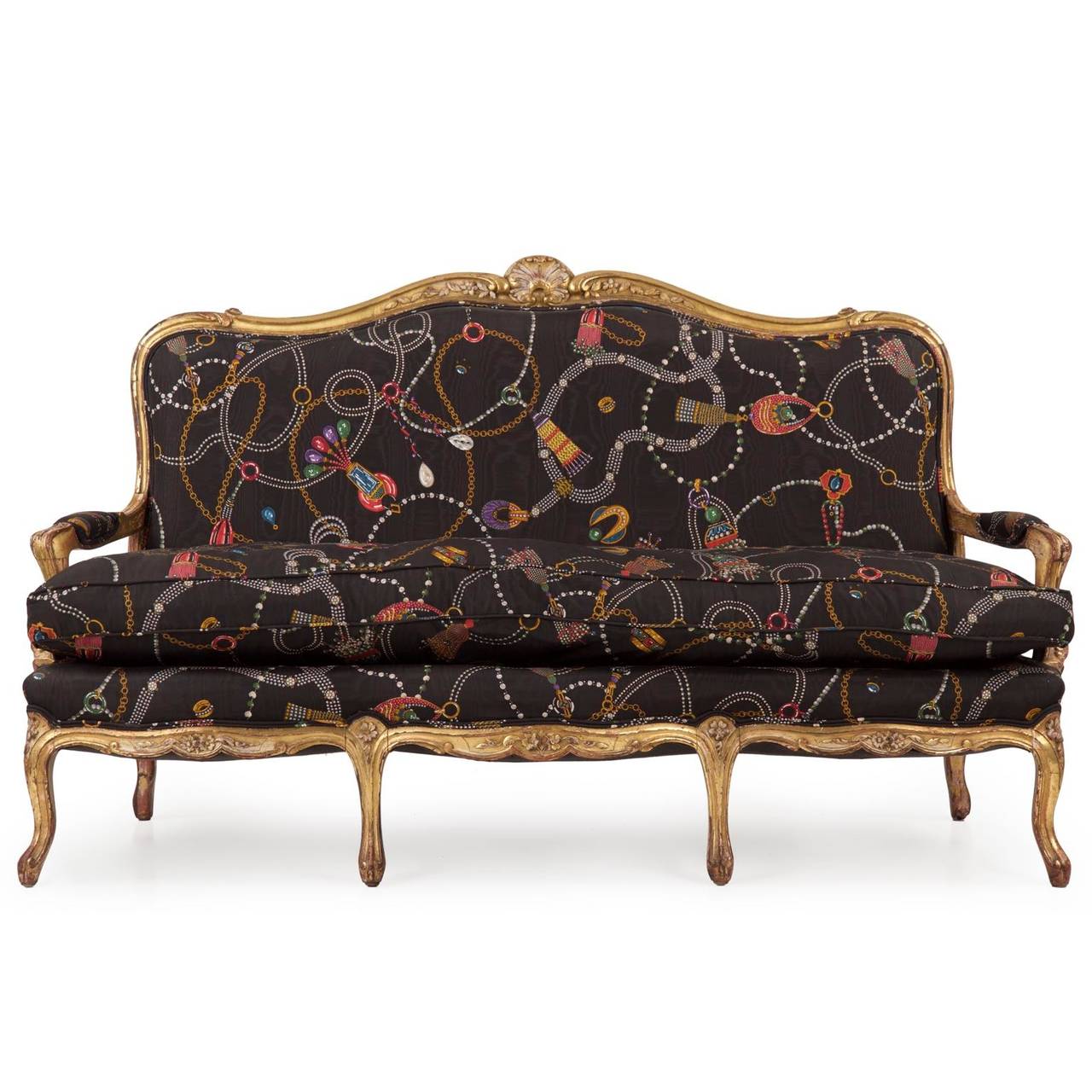 An exceedingly attractive piece preserved in quite fine condition, this French Louis XV style settee was probably crafted during the third quarter of the 19th Century circa 1860-1880.  The carved frame is exquisite, the crest with a fully developed