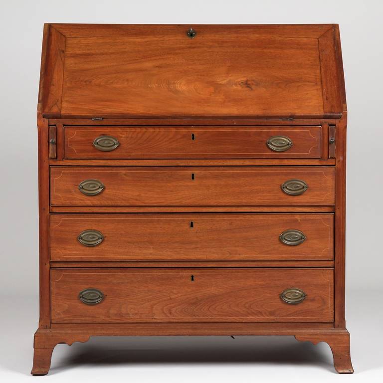 This is a very fine American Federal Period Slant Front Desk of Mid-Atlantic origin, crafted in solid walnut, circa 1790-1810. The lid is a highly figured single board (14 1/4