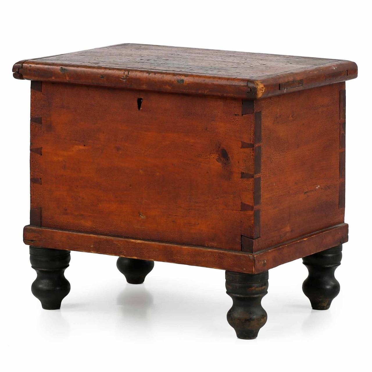 A rare and precious find, this very fine American miniature blanket chest is preserved in entirely original condition with an untouched surface and structure, retaining all original hardware and feet.  The red painted surface is dry and absolutely