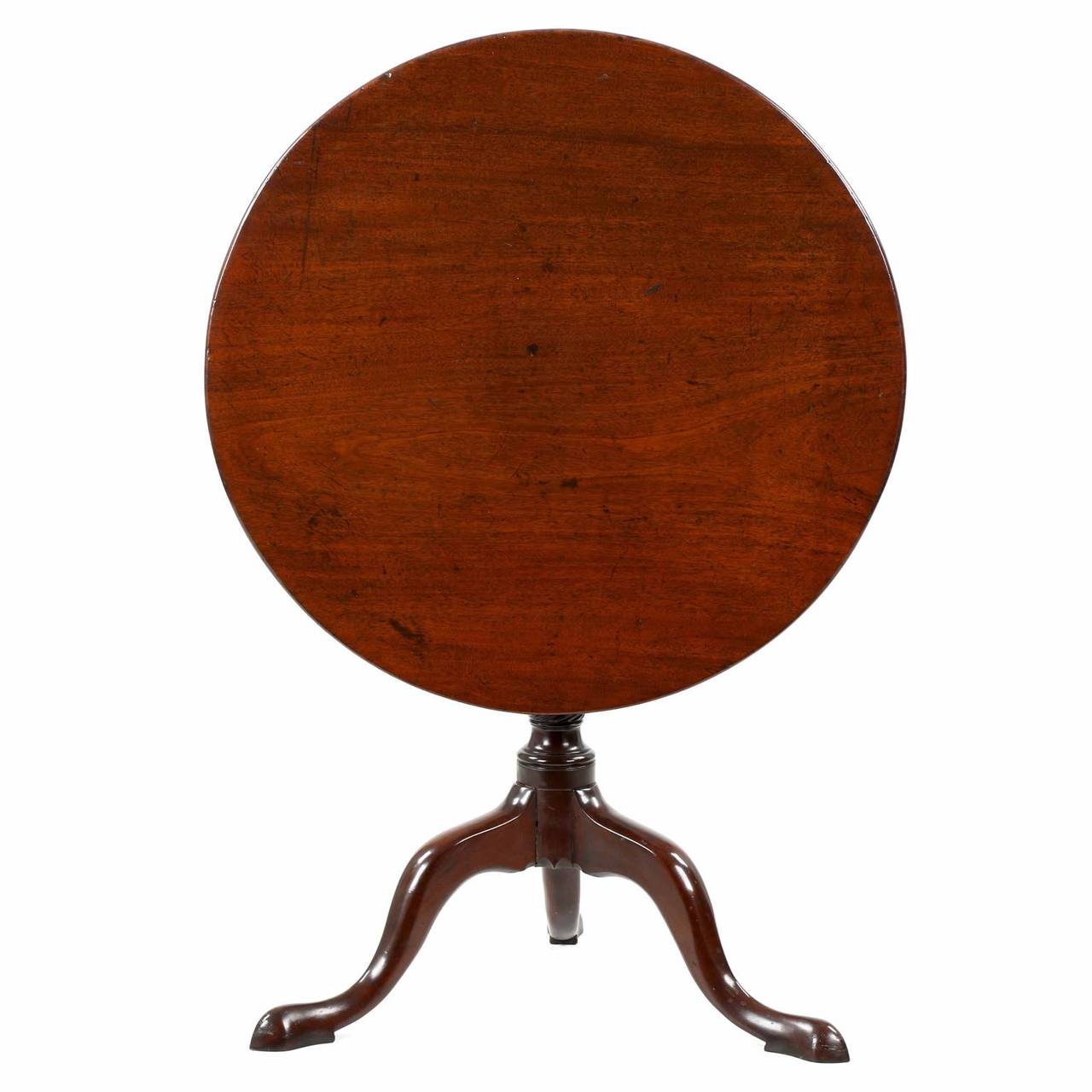 Using generous and very heavy selections of solid mahogany, this very attractive tea table of the George III period is particularly attractive for it's dense and vibrant single board top.  Planed by hand into a perfect round plank with curved edges,