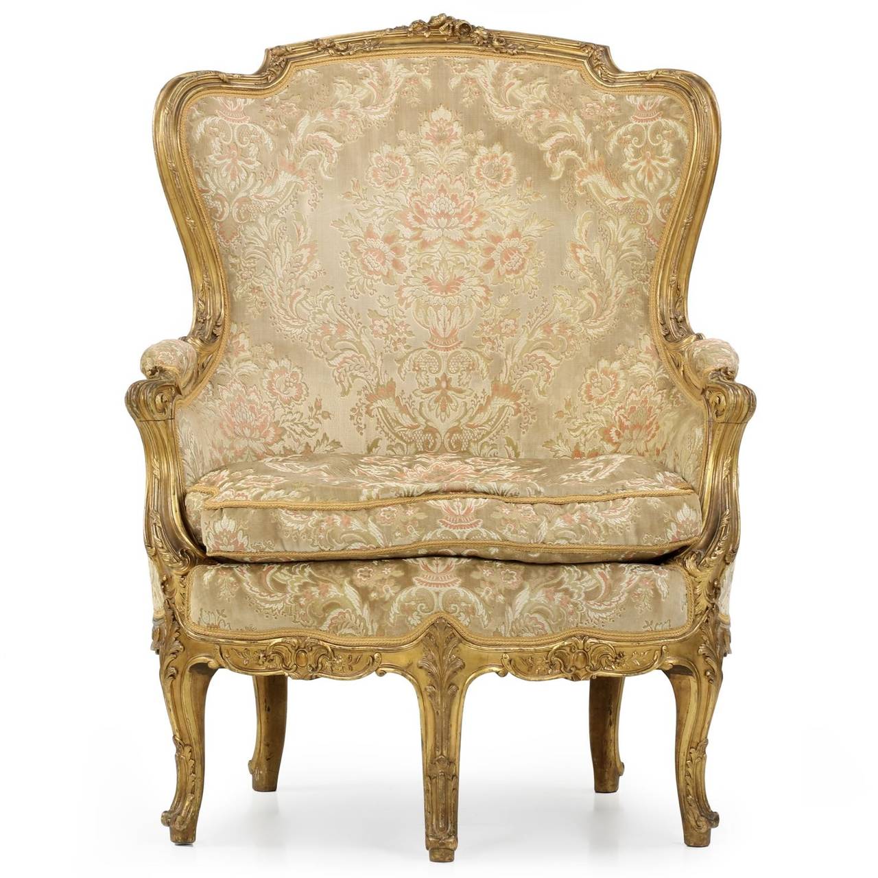 A rather rare five-legged design, this bergere styled after the Louis XV taste during the Napoleon III period is a finely carved and very rich display.  The frame exhibits a certain independence of hand that is always a wonderful thing to examine -