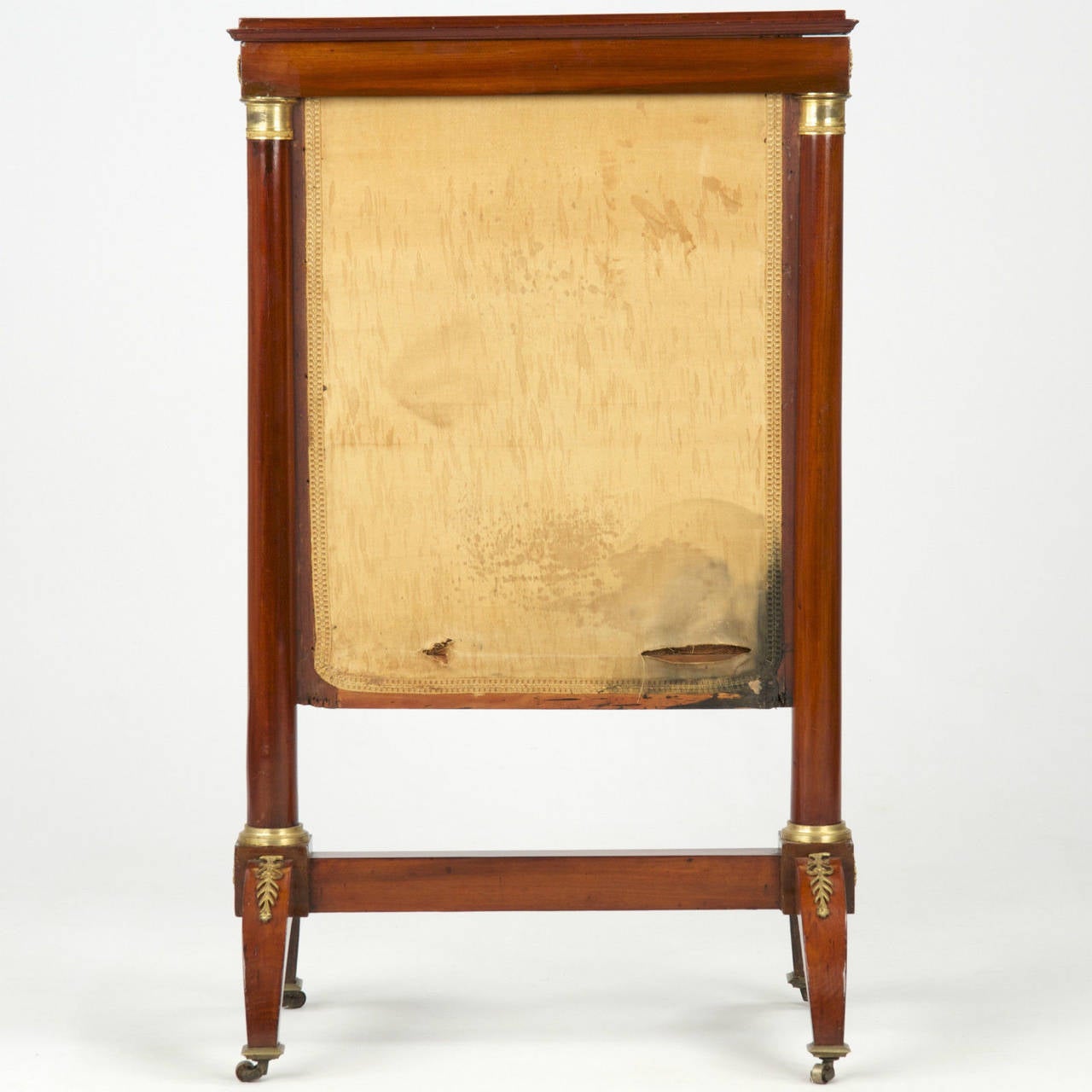 A very fine presentation piece, this firescreen frames an early hand-stitched tapestry depicting a classical scene of a figure kneeling while tending to the trunk of a tree. The tree is sawn midsection, but fresh branches and foliage have sprouted