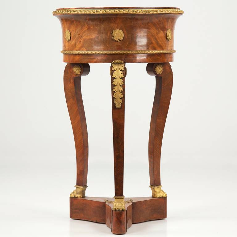 An incredibly striking stand from the first Empire, this fine object boasts magnificent golden veneers match booked and employed to create bursts of flame throughout all surfaces. The entire surface remains in very fine condition with only minor