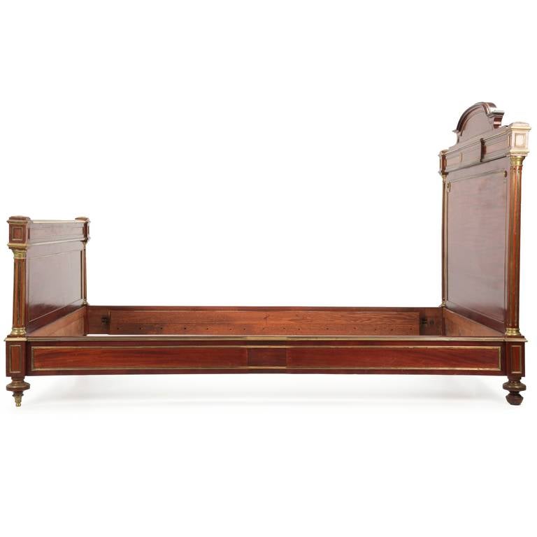 NAPOLEON III BRASS MOUNTED MAHOGANY BED
France c. 1880-1900

This gorgeous solid mahogany and mahogany veneered bed was crafted with utmost care during the late nineteenth to early twentieth centuries.  The deeply patinated and perfectly colored