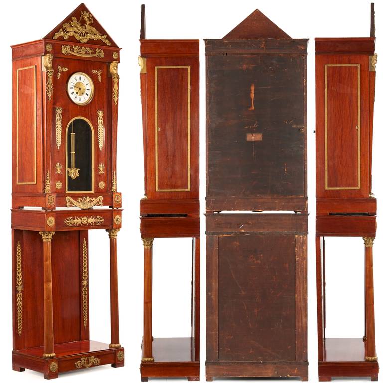 Heavily influenced by the euphoria for ancient Egypt so prevalent during the period, this longcase clock is appropriately embellished with a series of gilded mounts showing both the Egyptian and Neo-Grec taste of the era.  The triangular crest