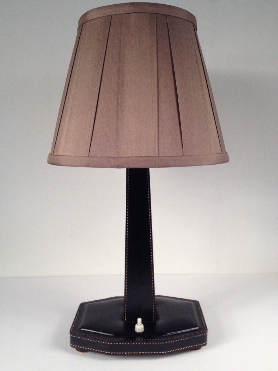 Decorative table lamp by Jacques Adnet for Hermès, France, 1950. This black leather stitched table lamp has a very cool look. The shade isn't original and it's not included. Lamp has been rewired and on dimmer, works perfectly.

Height with