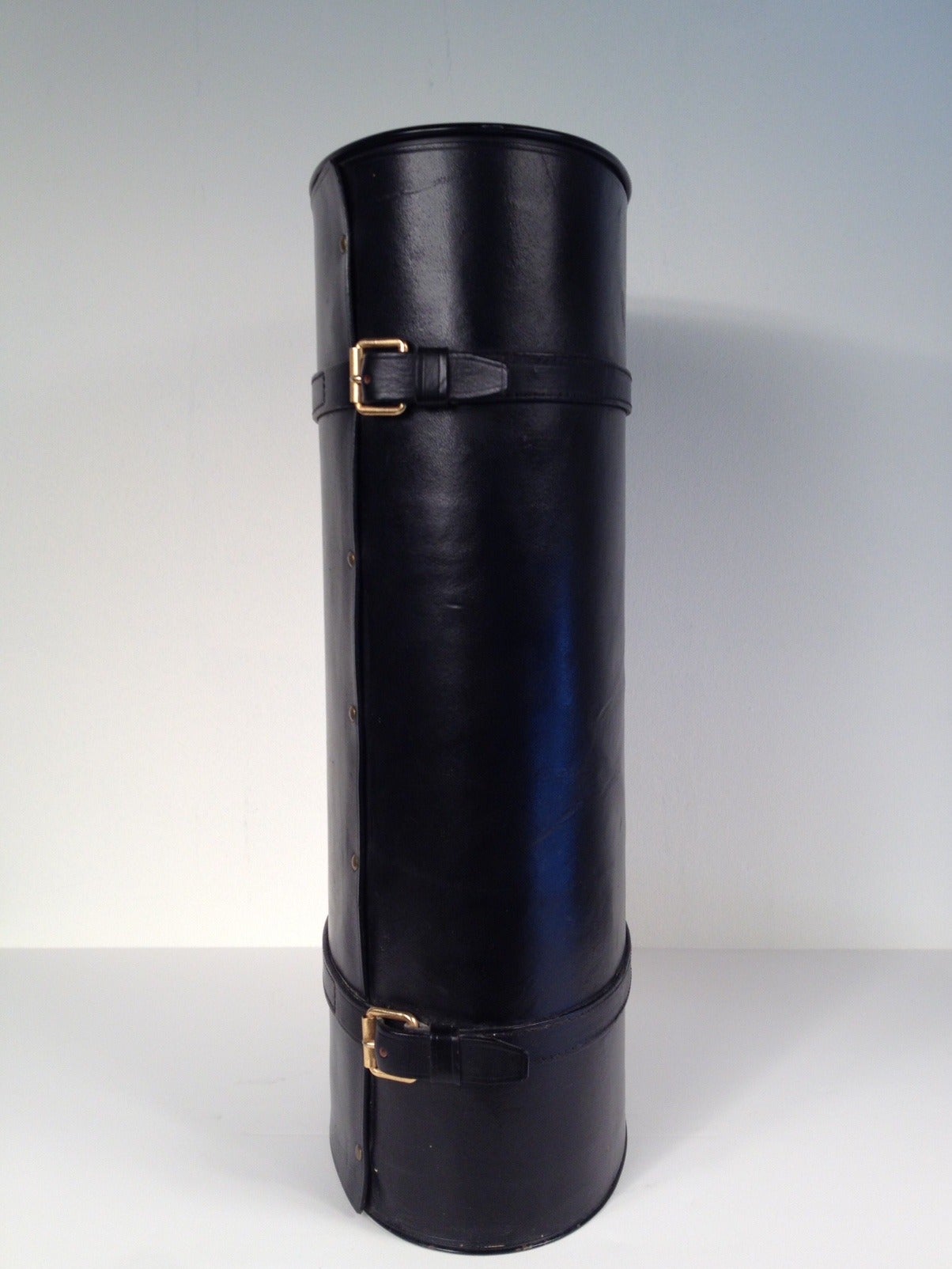 Tall French black leather oval umbrella stand. Two leather and brass buckles. Attributed to Jacques Adnet,
France, circa 1950.