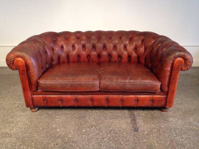 English cognac Chesterfield sofa with original leather. England, circa 1900.