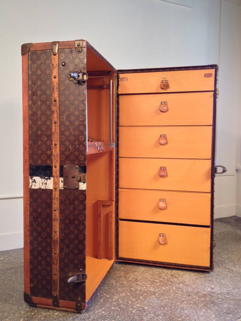 A Malle Armoire in L.V. Monogram canvas, the interior with six drawers in yellow Vuittonite canvas, the exterior with brass and leather trim, with original owners initials, M. A. K.