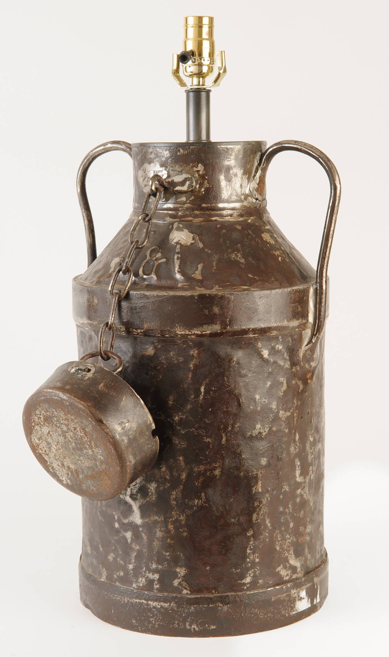Rustic French milk cans newly electrified for U.S. standards. These large-scale lamps make a strong statement for a country house or a Rocky Mountain log house. Measurements are for the base only.