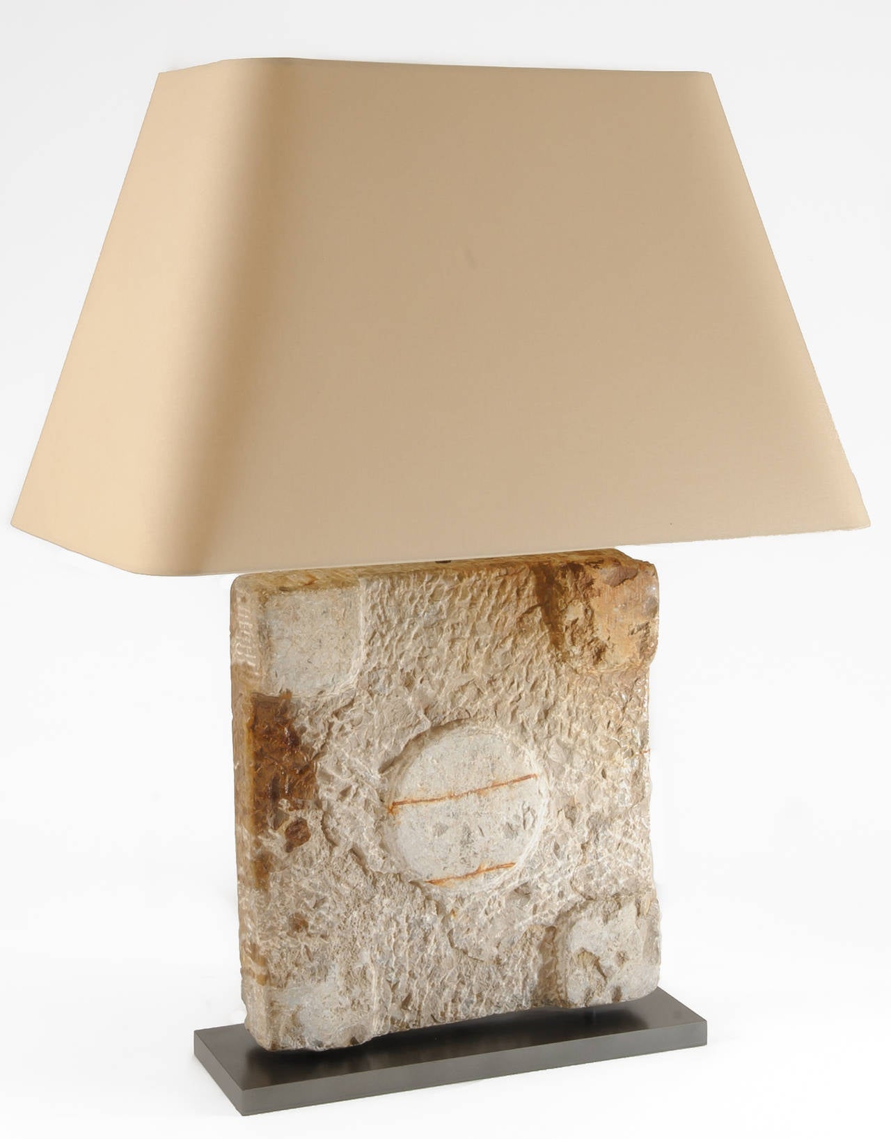 Architectural element: A stone base for Roman column is incorporated into a lamp base and mounted on a metal plate. The lamp has been electrified for US use. It has high and low in line switch. Overall height of lamp with shade: 30