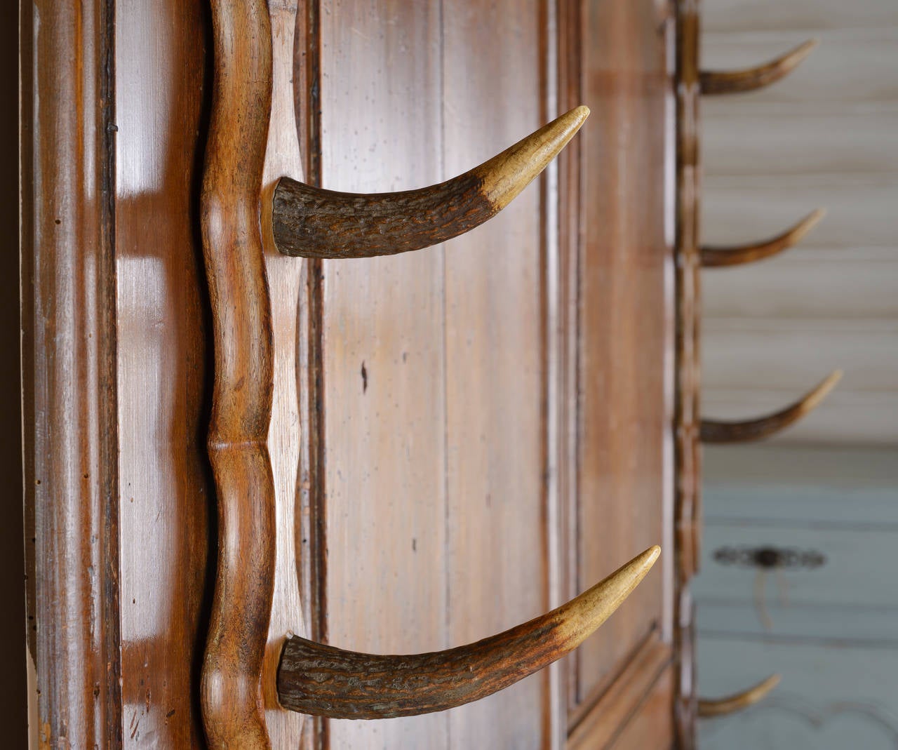 Louis XV doors have been made up to be a gun rack with stag horn brackets and shelf.  The wood is cherry and has a wonderful patina.
It alternatively could be used as a coat rack.