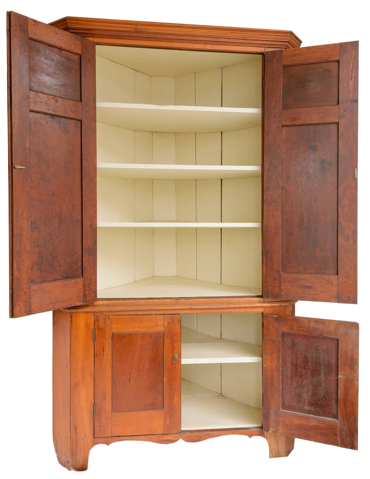 Cherrywood corner cupboard found in Kentucky. The corner cabinet has four doors with six blank panels on front. Beautiful exterior finish, painted shelves in upper cabinet. One lower shelf.