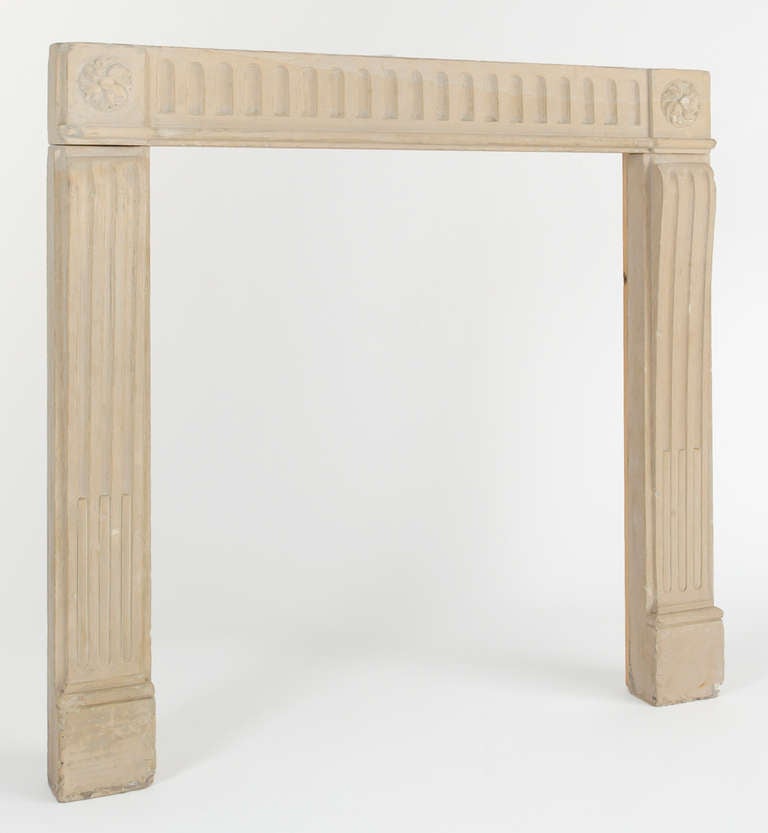 Charming limestone surround with channel detail on the apron and legs. There
is a carved rosette detail at each corner and plinth block.

Interior Measurements:  29.25 W   X  37H