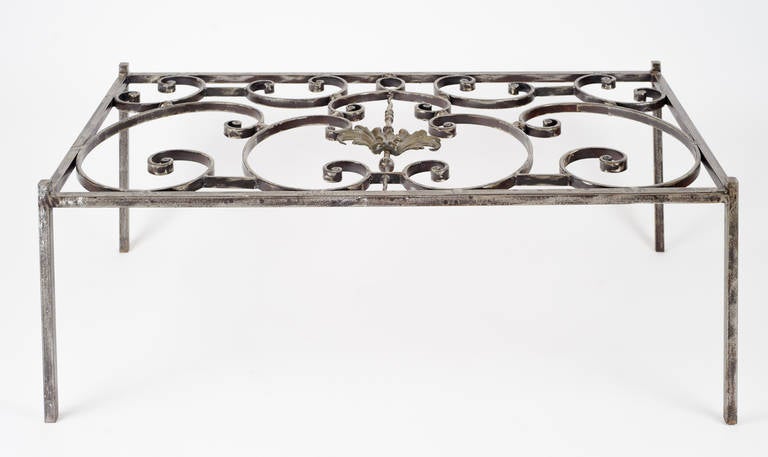 Antique iron window grill with a base of burnished steel. The raised corners allow any glass top to sit above the three dimensional grill pattern. At the center is an acanthus leaf pattern.