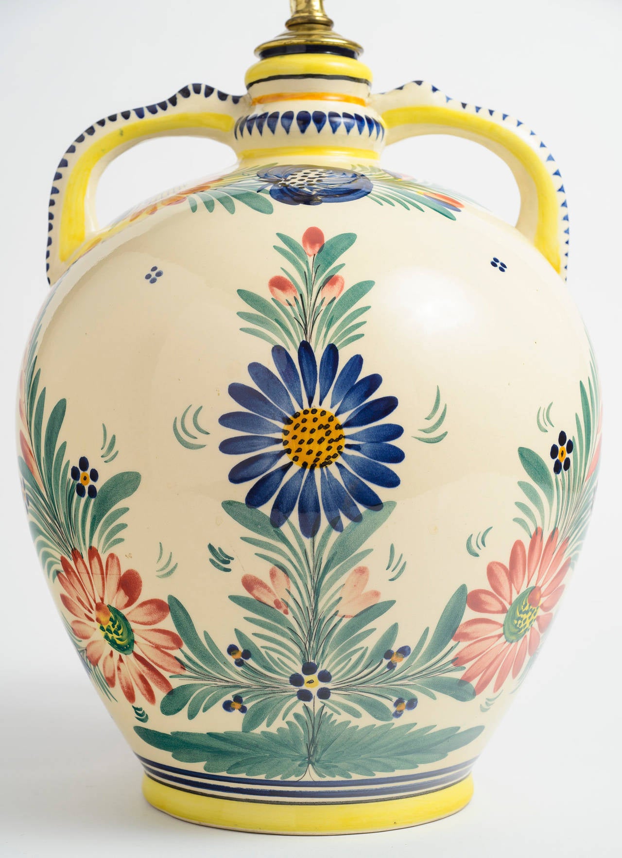 Large hand painted two handled jar, signed HB Quimper 531.  The bright colors are clear and fully surround the ceramic piece.  It has be made into a lamp with American wiring.  The jar is has not been drilled.    