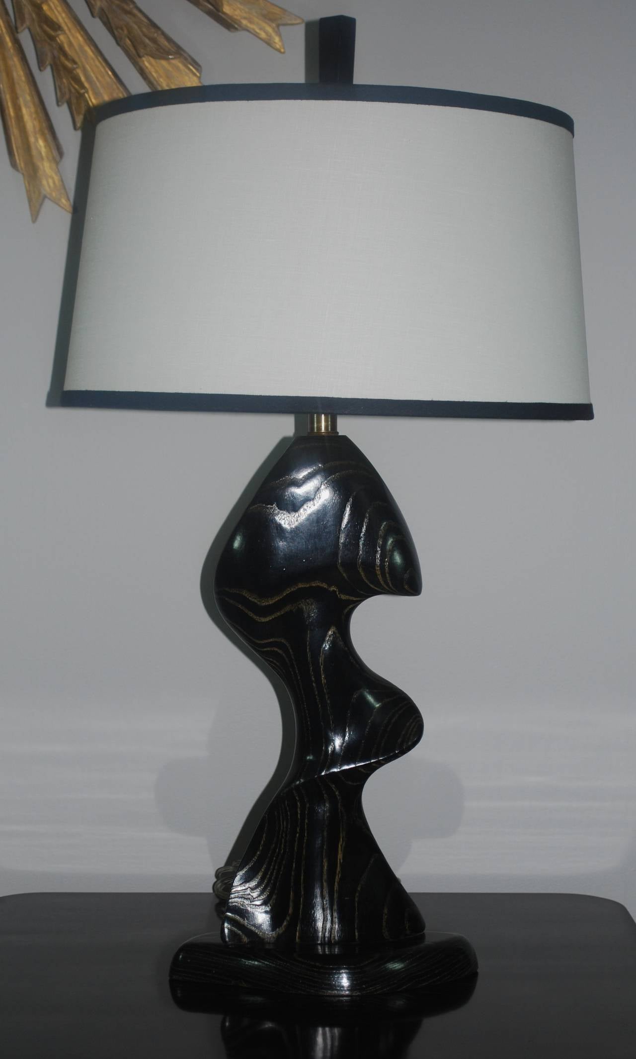 Impressively sculptural, black cerused table lamp. New linen shade with black contour. Newly rewired, circa 1960s.