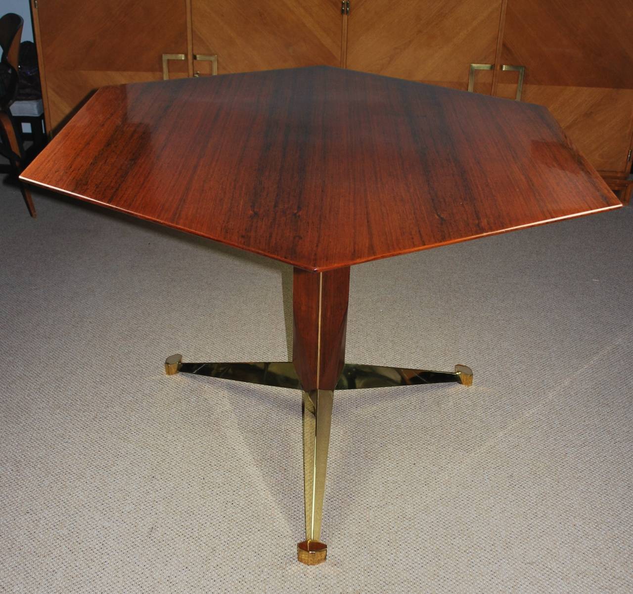 Beautiful Italian rosewood center table by Giulio Moscateli, hexagon shape with brass base and feet. Stunning grain. Excellent condition.

Please contact me to make sure item is available to view in gallery.