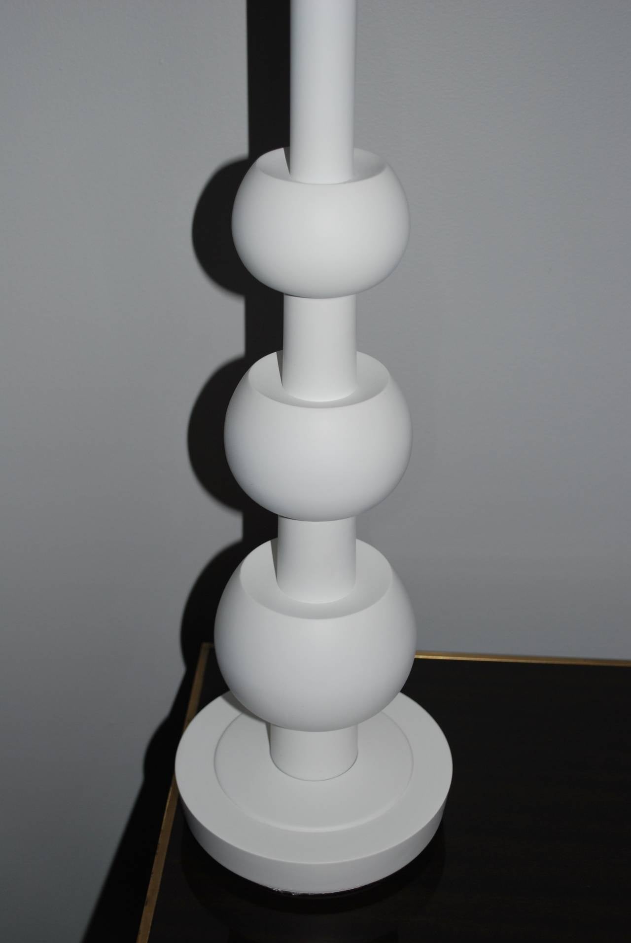 Pair of sculptural modern lamps with black shades. Three graduating balls, newly refinished in plaster-like white. Lamps have been newly rewired.