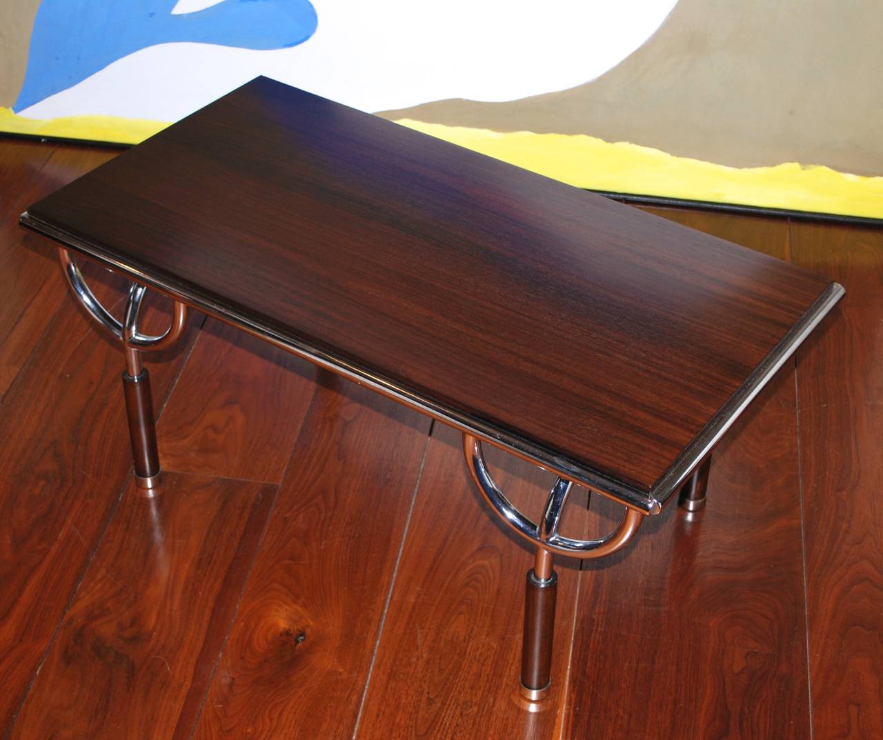 Newly refinished pair of walnut tables by Aimaro Isola and Roberto Gabetti, 
Italy, circa 1970. Italian walnut top over chromed steel legs with U-shaped supports,
chrome trim to edge. Great sculptural design. May be used as cocktail or side tables.