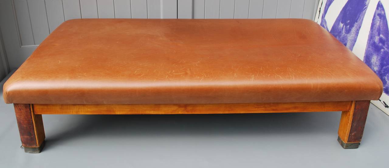 Impressive scale French daybed or gym bench, France 1950s.
Top has been upholstered later in distressed cognac leather. Great metal rings and detail. Very sturdy construction. Great look and character.

Please contact me to make sure daybed is