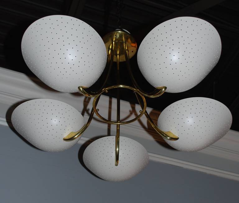 Italian brass chandelier with five lights cream enameled and perforated shades.
Light is newly refinished, polished and rewired.