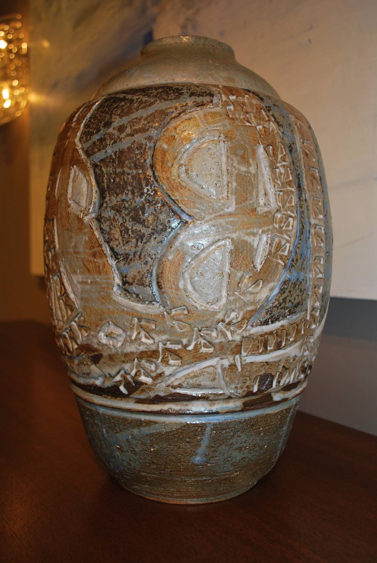 Large vase, glazed earthenware, dated 1976 by Tobias Weissman. Carved and stamped abstract design. Beige, brown, cream and blue colors.
Signed underneath. Great colors and texture!