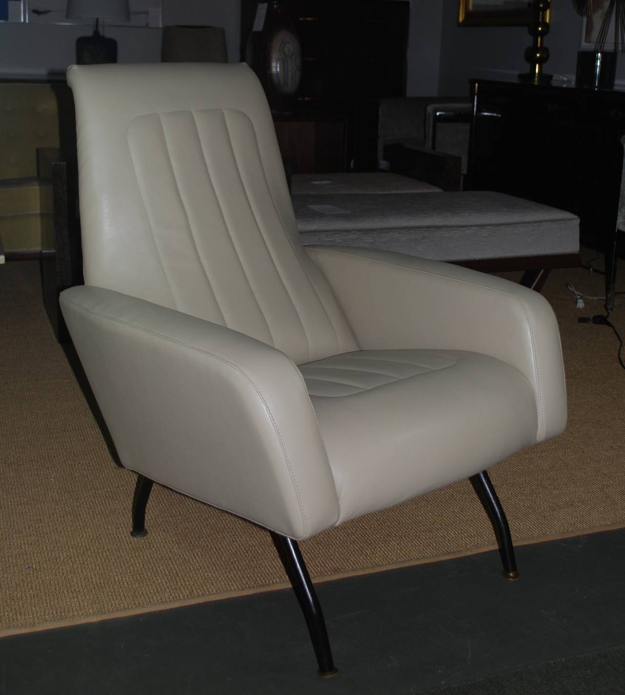 Mid-Century Modern Italian chairs with metal legs. Graceful lines, newly upholstered in tan faux leather.

Please check with me to make sure item is available to view in the gallery.