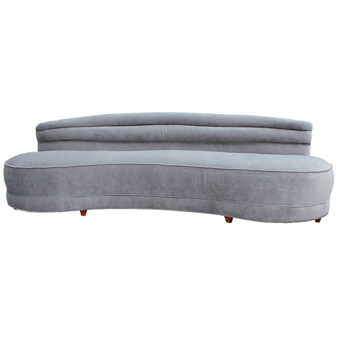 Stunning curved sofa from the 1930-1940s. Elongated bean shaped sofa is beautiful and fully refurbished. Sofa has all new foam and is covered in luxe dove grey velvet. Horizontal channel back adds visual interest.