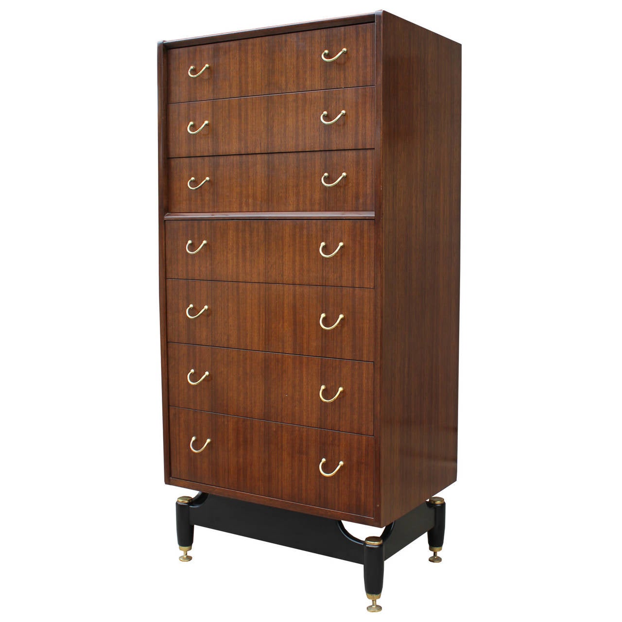 Wonderful lingerie chest sits atop a black lacquered base with shiny brass levelers and accents.  Seven drawers provide ample storage.  Beautiful grain and excellent construction.