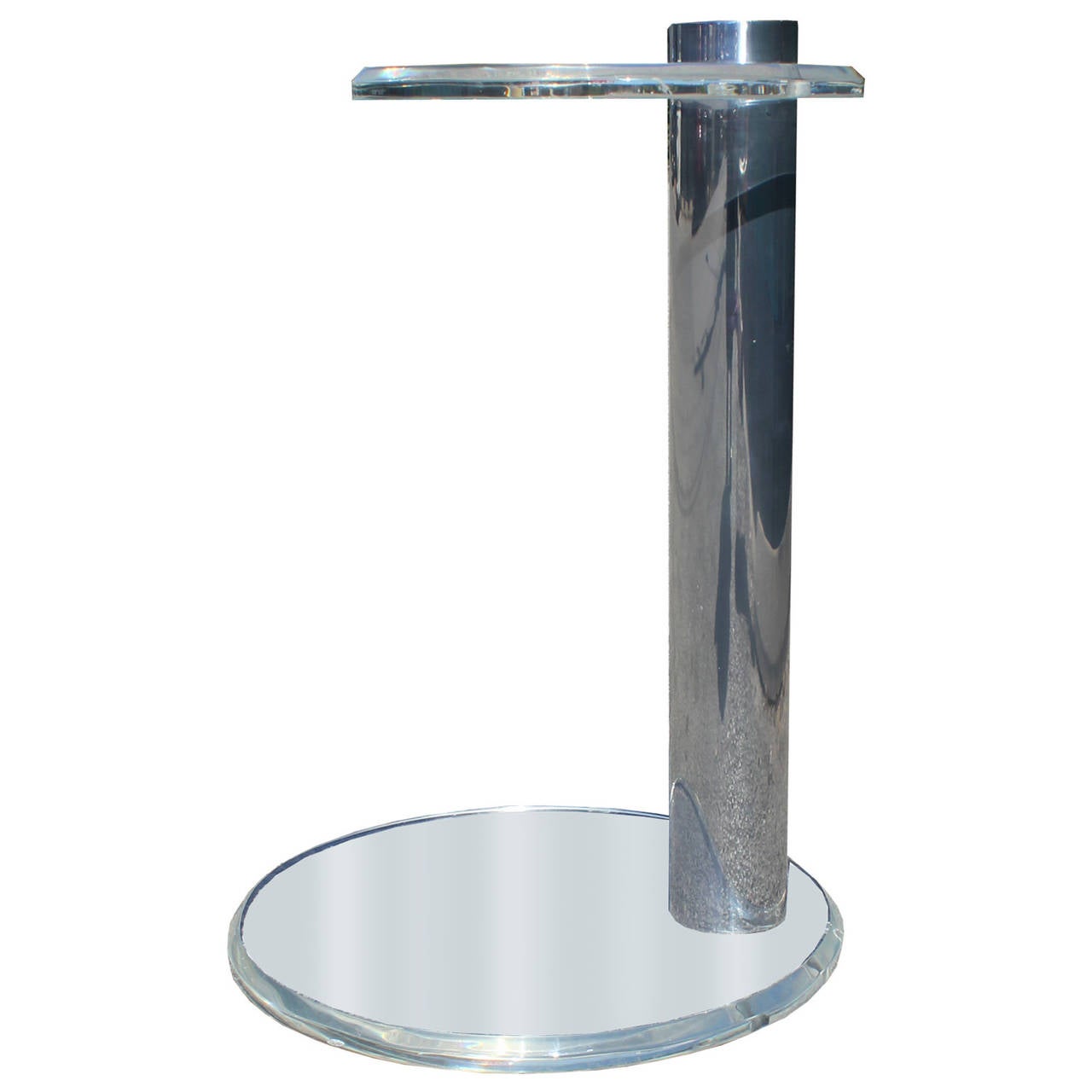 Clear lucite and reflective chrome make this piece blend seamlessly into any space.