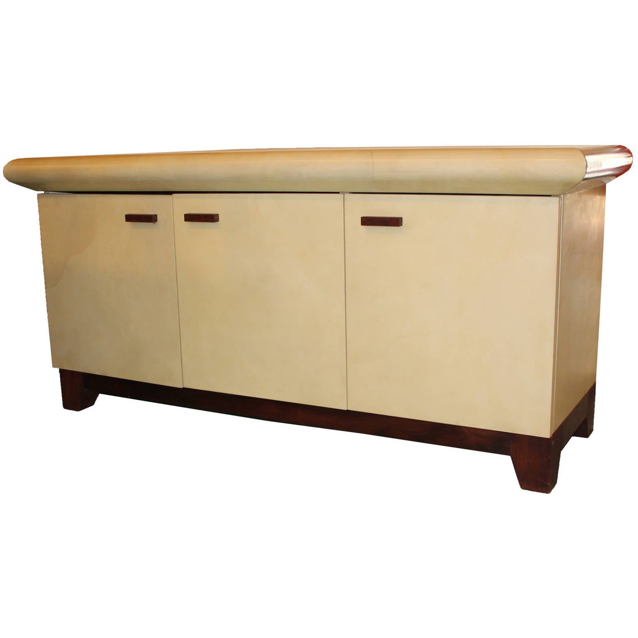 Fabulous sideboard covered in lacquered goat skin. Finish feels incredibly smooth. A walnut wood base and handles give this piece a nice touch. Three doors open to reveal adjustable shelves with ample storage.