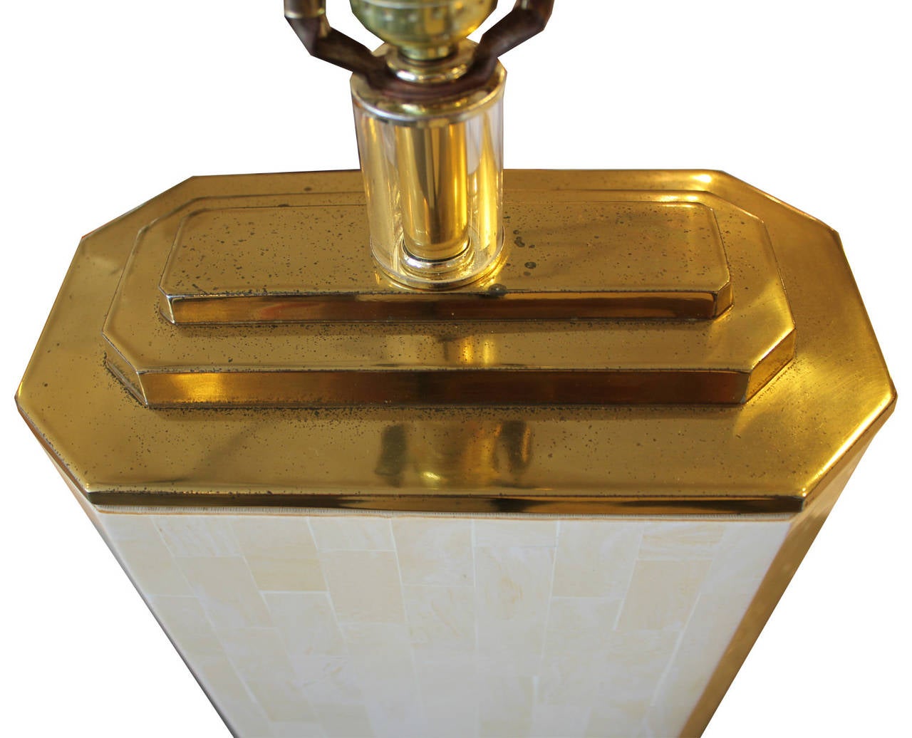 Beautiful table lamp attributed to Karl Springer. Tiled bone sits atop a sparkling lucite base. Lamp is topped with stepped brass and a lucite finial. In excellent working condition.