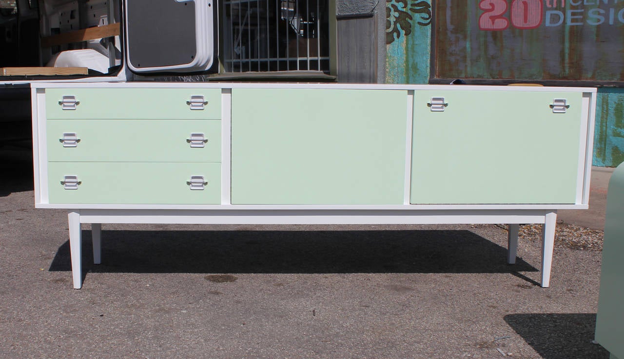 Excellent mint and white lacquered sideboard with chrome handles. Sideboard / credenza is in excellent restored condition.