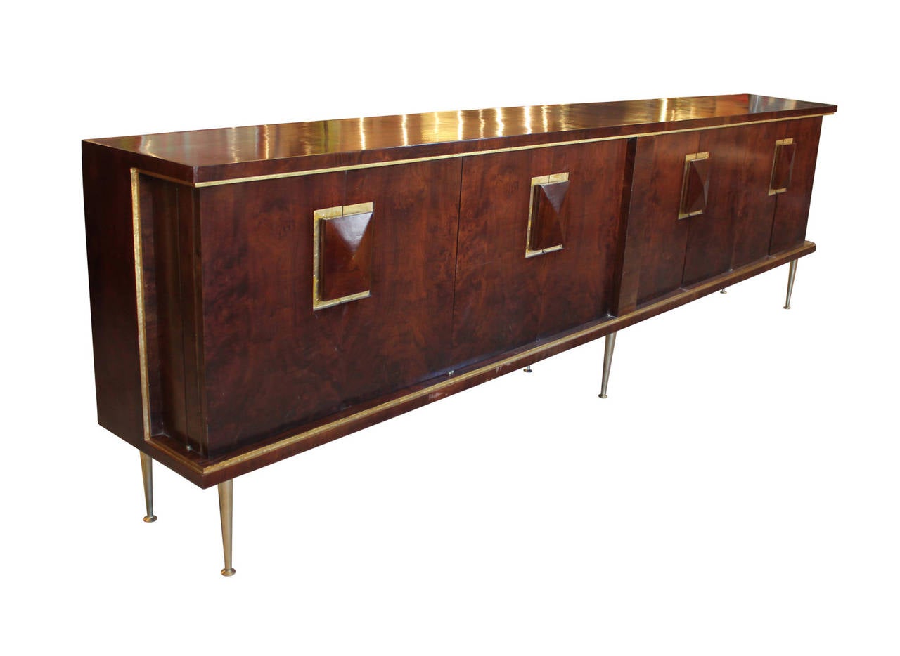 Stunning 10ft Italian sideboard with turned brass legs and a beautiful grained burl wood. Handles are dressed with gold leaf surrounds. In excellent vintage condition. This is a show stopper.