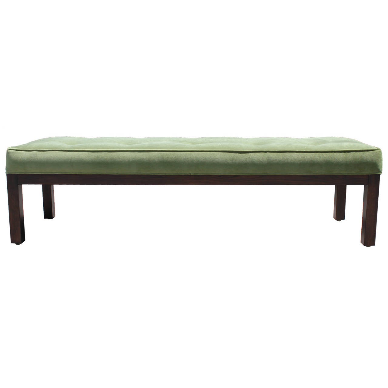 Wonderful Parsons style bench. Base is stained a dark walnut. Cushion is upholstered in luxe green velvet with tufting and piping. Perfect at the end of a bed.