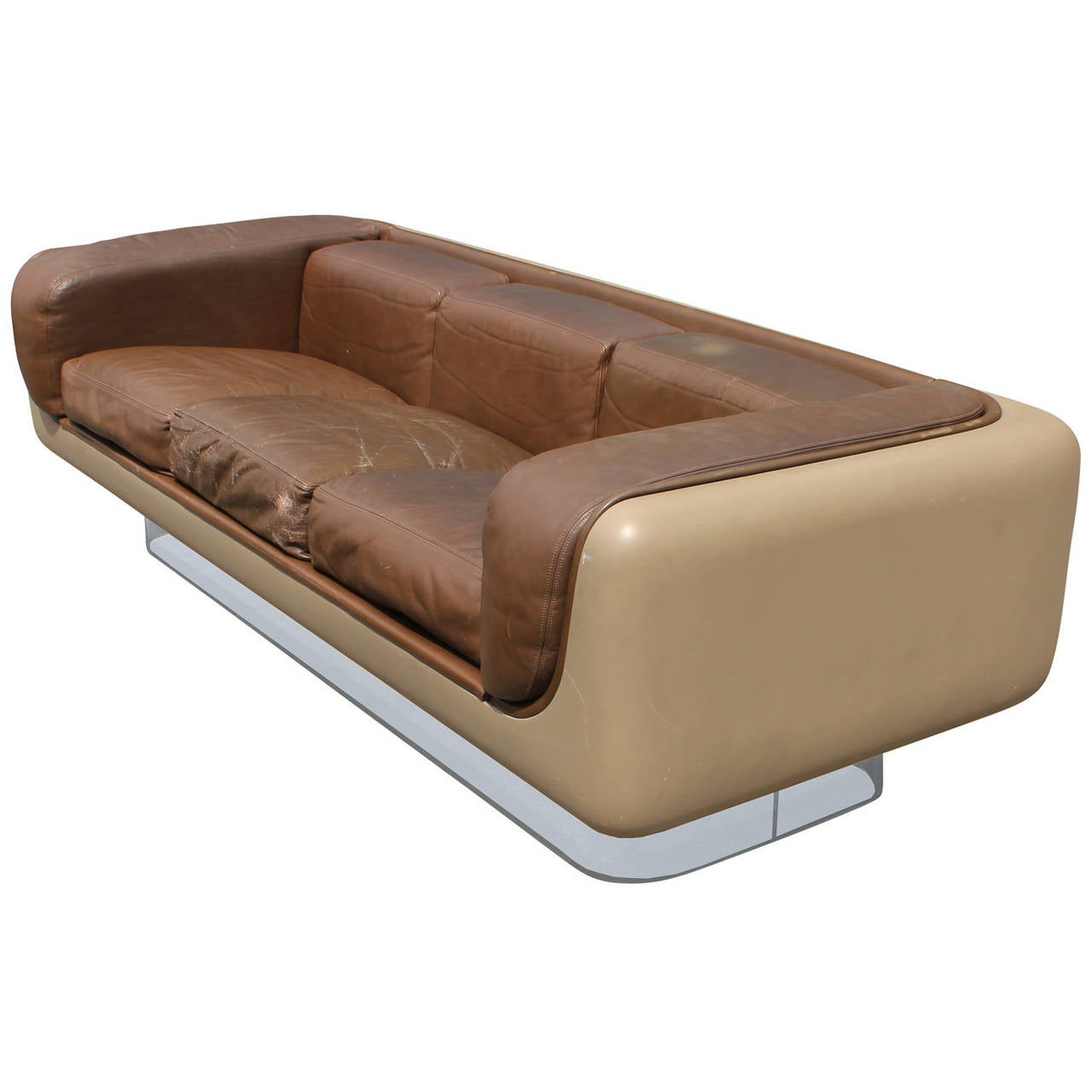 Pair of wonderful fiberglass sofas designed by William C. Andrus for Steelcase. Sofas are from the 465 Soft series designed in 1972. Sofas sit upon Lucite bases to create a floating look. Sofas are upholstered in the original brown leather. Leather