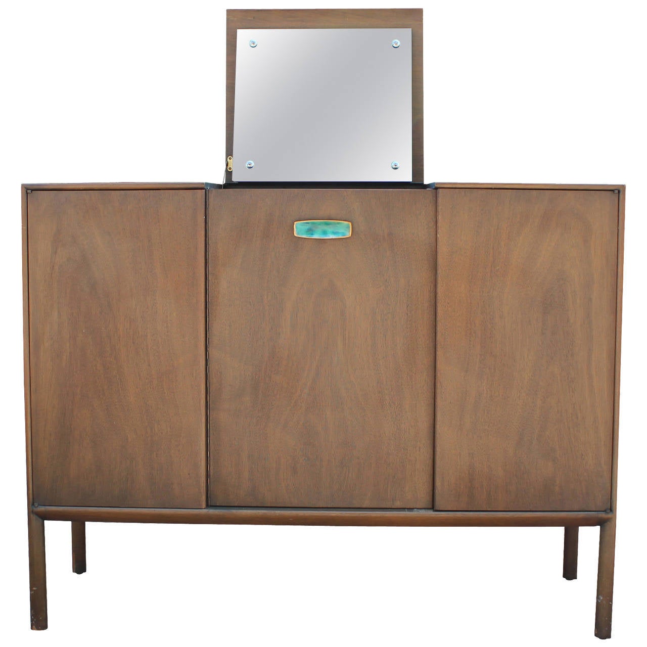 Beautiful and clean lined gentlemen's Chest by Ray Sabota for Mt. Airy.  A single green enamel handle adds visual interest. Center flip top drawer opens to reveal a mirror. Left door opens to four small drawers. Center and right doors open to three