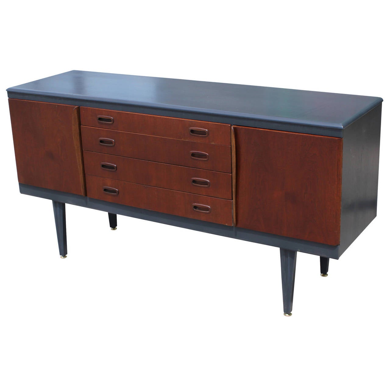 Sophisticated two-tone credenza. Doors and drawers are finished a medium tone walnut while the body of the piece is finished in a matte dark grey. Four drawers provide ample storage. Tapered legs are beveled to provide interest.