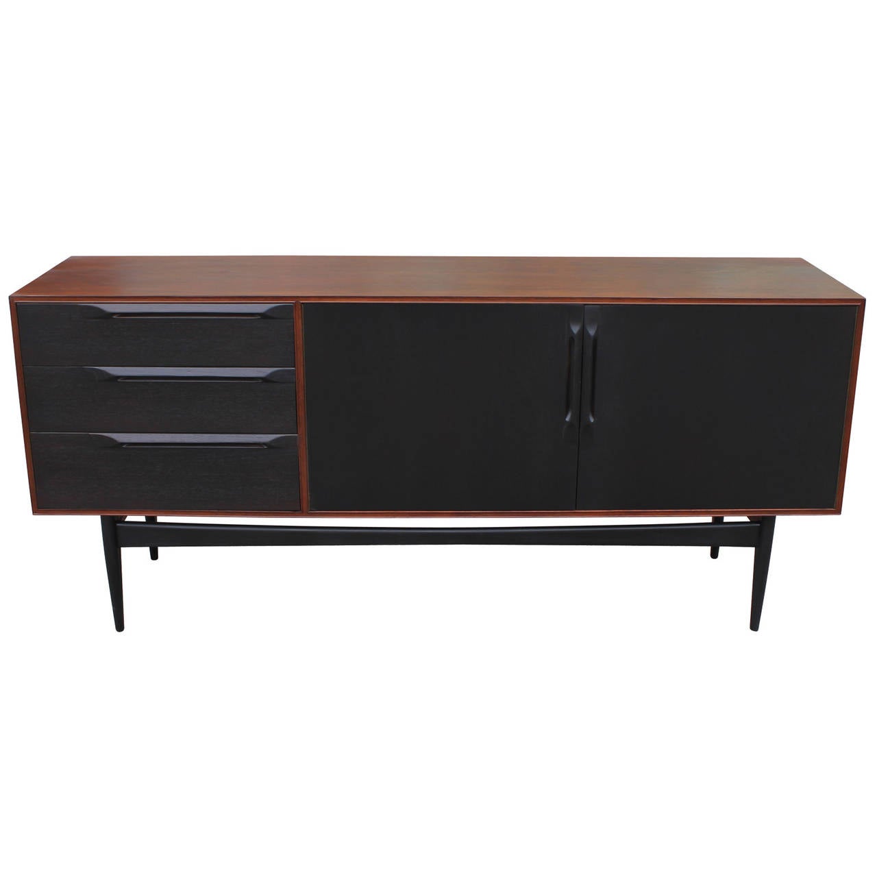 Sleek two tone sideboard with a walnut color shell and ebonized middle. Sideboard has been professionally restored. Beautiful piece.