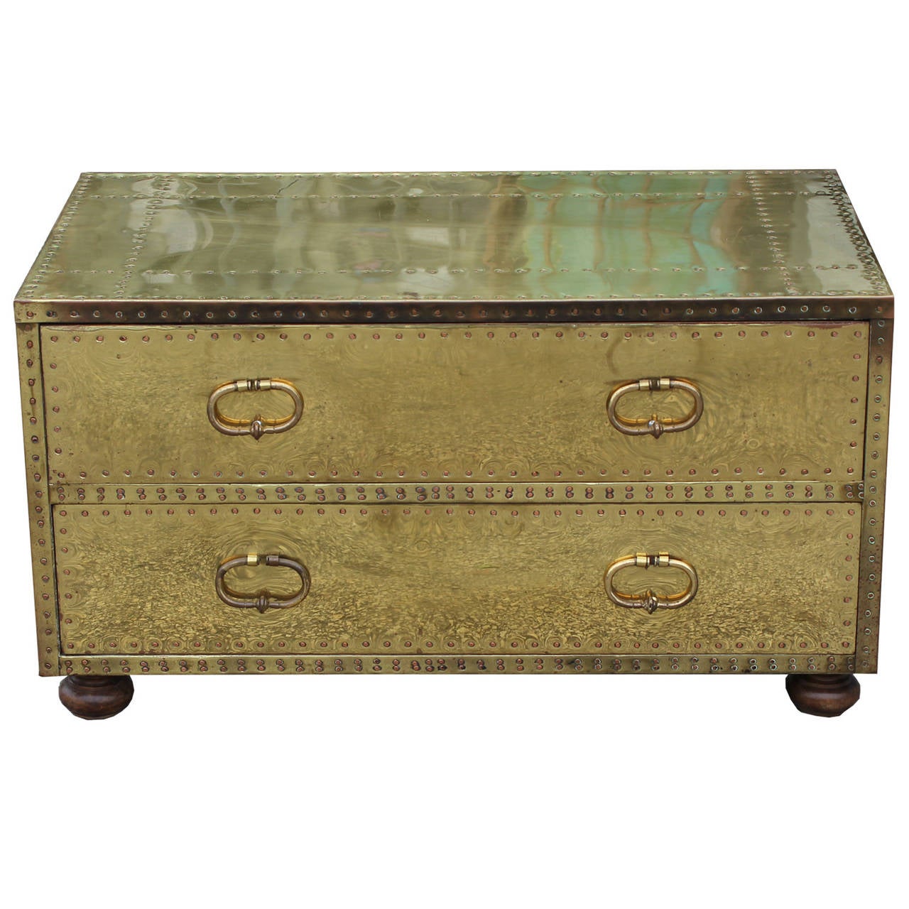 Great little campaign style brass chest by Sarreid. Brass has a wonderful warm patina. Chest sits atop small wooden bun feet. Would be great as a nighstand or side table.
