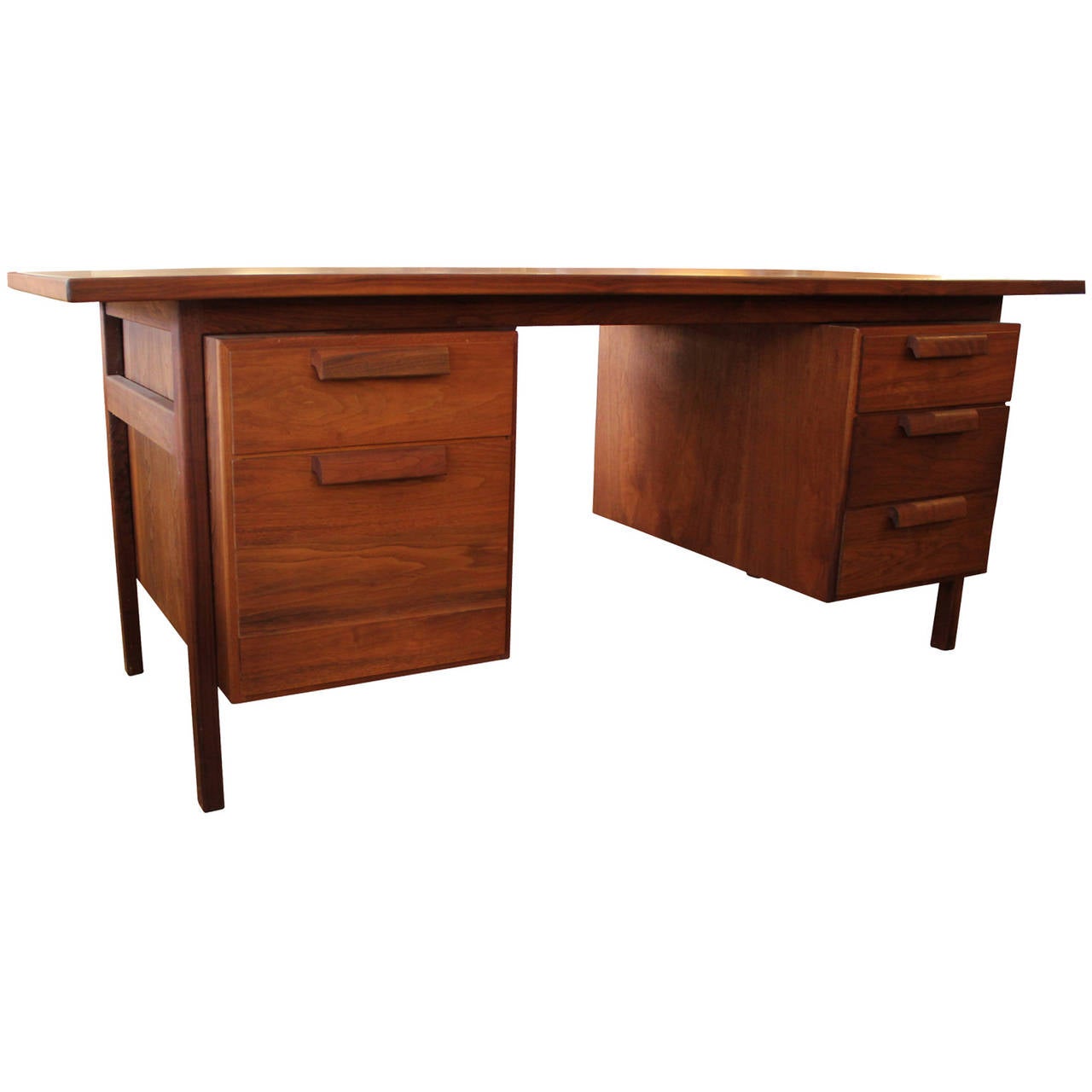 Wonderful rare executive desk by Jens Risom. Top drawers on either side open to reveal a sectioned space. Bottom left drawer is for filing. Original Tags still remains partially intact. Desk has a oiled walnut finish.