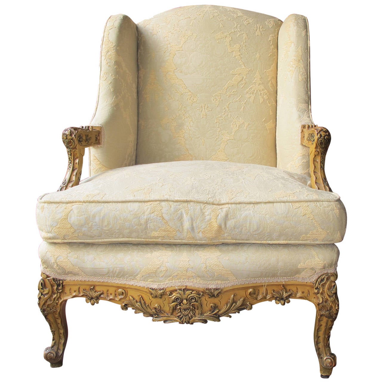Beautiful Louis XIV style Bergere chair. Chair has intricate detailing with a down cushion. Currently upholstered in a neutral damask.