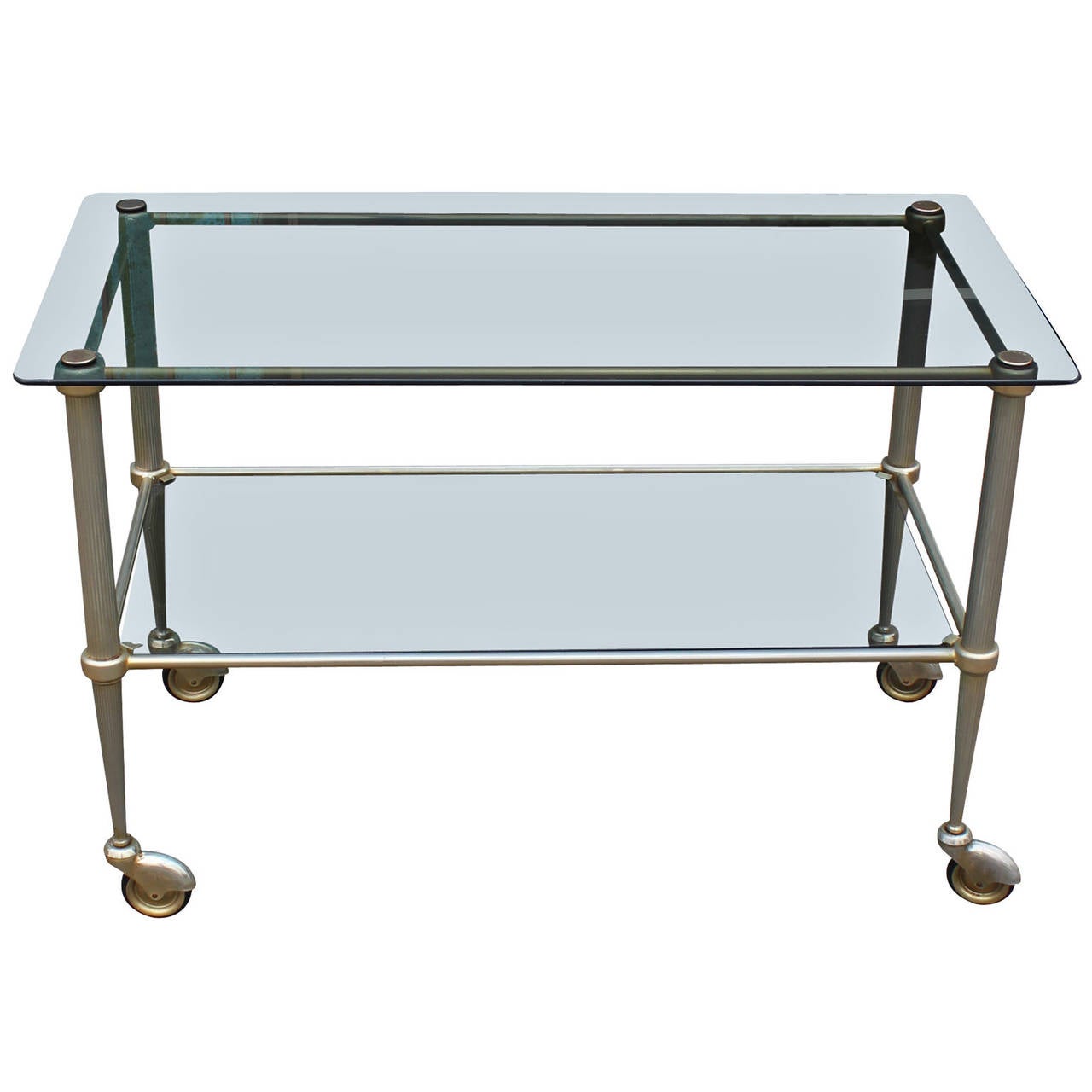 Beautiful bar cart in a soft aged brass. Cart is fitted with two smoked glass shelves. Cart has delicate tapered legs. Perfect in a Hollywood Regency interior.
